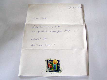 Der Gruß ist von Hand auf einem weihnachtlichen Briefpapier geschrieben.